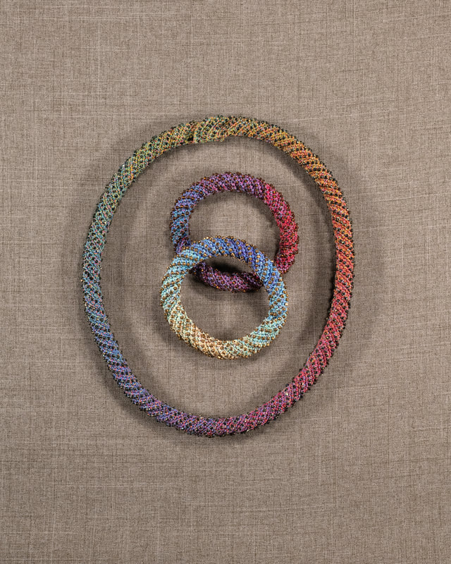 Elizabeth Tuttle, Dark Rainbow Rope Collar and Bracelets. Crocheted cotton sewing thread with glass beads. [un-tied]