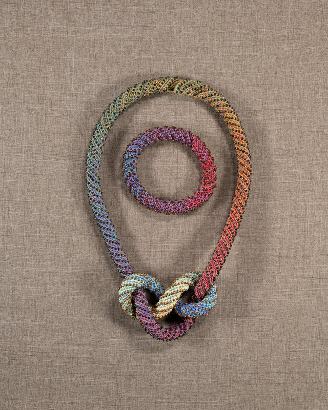 Elizabeth Tuttle, Dark Rainbow Rope Collar and Bracelets. Crocheted cotton sewing thread with glass beads. [Tied]